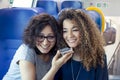 Two smiling lovely girls using a smartphone Royalty Free Stock Photo