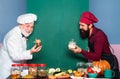 Two smiling male chefs, cooks or bakers with menu blank board. Kitchen chef. Happy Chef showing Menu Board.