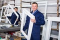 Two smiling men professional labours with finished PVC profiles and windows Royalty Free Stock Photo