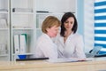 Two smiling nurses working at hospital reception desk Royalty Free Stock Photo