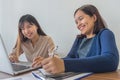 Two smiling office girls having interesting conversation in their meeting