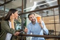 Two smiling office workers having coffee break Royalty Free Stock Photo
