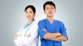Two Smiling Physicians In Uniform, Concept Of Clinic Staff Teamwork