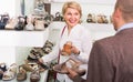 Two retirees together choosing pair of shoes in fashion store Royalty Free Stock Photo