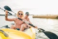 Two smiling rowers father and son on inflatable yellow kayak rowing by the evening sunset rays Adriatic sea harbor in Croatia near Royalty Free Stock Photo