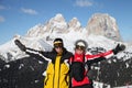 Two smiling skiers in mountains