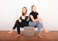 Two teenage girls - sitting smiling friends