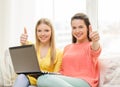 Two smiling teenage girls with laptop at home Royalty Free Stock Photo