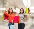 Two smiling teenage girls with shopping bags Royalty Free Stock Photo