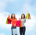 Two smiling teenage girls with shopping bags Royalty Free Stock Photo