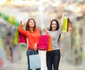Two smiling teenage girls with shopping bags Royalty Free Stock Photo
