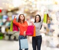 Two smiling teenage girls with shopping bags Royalty Free Stock Photo