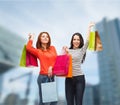 Two smiling teenage girls with shopping bags Royalty Free Stock Photo