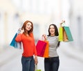 Two smiling teenage girls with shopping bags Royalty Free Stock Photo