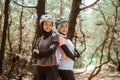 two smiling veiled women standing back to back while cycling