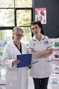 Two smiling woman pharmacy specialists in drugstore portrait