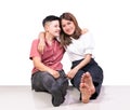 Two smiling woman young girls and happiness tomboy friends sitting on tile floor with white background Royalty Free Stock Photo