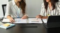 Two women office workers working together in office. Royalty Free Stock Photo