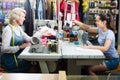 Two smiling women tailors working with sewing machines Royalty Free Stock Photo