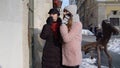 Two smiling women tourists looking at shop window on city street, family couple talking, embracing Royalty Free Stock Photo