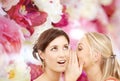 Two smiling women whispering gossip Royalty Free Stock Photo