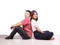 Two smiling woman young girls and happiness tomboy friends sitting back to back on tile floor in home with white background Royalty Free Stock Photo