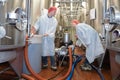 Two smiling workers in white coats at brewery factory Royalty Free Stock Photo