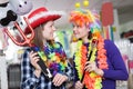 Two smiling young female friends having fun in festival outfits store Royalty Free Stock Photo