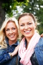 Two smiling young women in a park Royalty Free Stock Photo