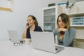 Two Smiling Young women working at laptop at office Royalty Free Stock Photo
