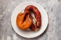 two smoked sausages on white small dish Royalty Free Stock Photo