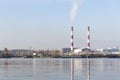 Two smoking chimneys on the river bank Royalty Free Stock Photo