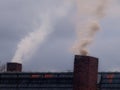 Two smoking chimneys Royalty Free Stock Photo