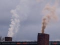 Two smoking chimneys Royalty Free Stock Photo