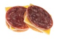 Two snack crackers with dry salami and gouda cheese on a white background Royalty Free Stock Photo