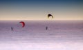 Snow kiters gliding in the sun on snow and ice an awesome feeling