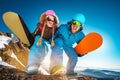 Two snowboarders male and female having fun and posing Royalty Free Stock Photo