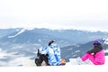 Two snowboarders are sitting on a high mountain slope Royalty Free Stock Photo