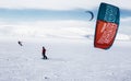 Two snowkiter rides on a snow-covered field in the Arctic. Murmansk region