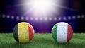 Two soccer balls in flags colors on stadium blurred background. Belgium and Italy.