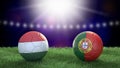 Two soccer balls in flags colors on stadium blurred background. Hungary and Portugal. Royalty Free Stock Photo