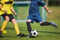 Two soccer players compete in a duel. Footballers kicking ball