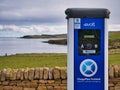 A two socket, blue, evolt ChargePlace Scotland in a remote, coastal setting at the Visitor Centre car park in Hoswick, Shetland,