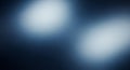 Two soft, luminous white blurred circles on a deep dark blue abstract gradient background with subtle light diffusion Royalty Free Stock Photo