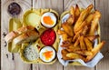 Two soft boiled eggs with fries and sauces. Royalty Free Stock Photo