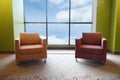 Two soft chairs in large panoramic window. View of the sky and clouds