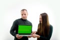 Two software developers analyzing source code looking at green screen chroma key mockup with coworker sitting at desk