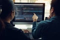 Two software developers are analyzing together about the code written into the program on the computer