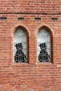 Two soldier silhouettes in windows of red brick building Royalty Free Stock Photo