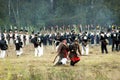 Two soldiers carrying a wounded sodlier